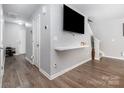 Open-concept living room featuring hardwood floors, a large TV, and neutral paint at 2046 E Park Dr, Lancaster, SC 29720