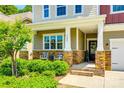 Inviting front porch with stone accents, decorative seating, and well-maintained landscaping at 3005 Oakmere Rd, Waxhaw, NC 28173
