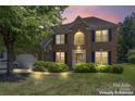 Lovely brick home featuring lush green landscaping, manicured lawn and a two-car garage at 3124 Arklow Rd, Charlotte, NC 28269