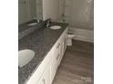 Bathroom featuring double sinks with granite countertops and white cabinets at 331 Nesbit Ave, Mooresville, NC 28115