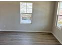 Bright bedroom with two windows, neutral walls, and modern flooring at 331 Nesbit Ave, Mooresville, NC 28115