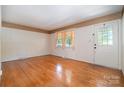 Bright living room with hardwood floors, neutral walls, and natural light streaming through a large window at 3624 Delgany Dr, Charlotte, NC 28215