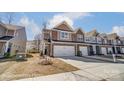 View of modern townhome exteriors with brick and siding, complemented by well-kept lawns at 4254 Black Ct # 231, Harrisburg, NC 28075