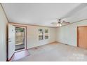 Well-lit living room with an open door leading to a view of the front yard at 4408 Robins Nest Rd, Concord, NC 28027