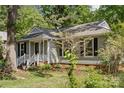 Single-story home featuring gray siding, black shutters, and a well-maintained front yard at 6412 Old Meadow Rd # 69, Charlotte, NC 28227