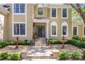 Close up view of the home's entrance, showcasing the front door, fountains, manicured landscape and walkway at 6914 Riesman Ln # 95, Charlotte, NC 28210