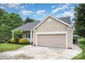 Well-maintained single-story home with a two-car garage, covered porch, and landscaped front yard, offering a welcoming facade at 7106 Kinsmore Ln, Charlotte, NC 28269