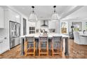 Bright kitchen featuring hardwood floors, a large island with seating, and modern appliances at 8136 Energy Ln, Catawba, NC 28609