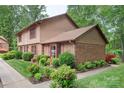 A well-maintained townhouse with a brick exterior and neat landscaping, highlighting its curb appeal at 119 Mary Louise Ct, Fort Mill, SC 29715
