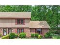 Townhome featuring brick and siding with manicured landscaping, vibrant greenery, and symmetrical design at 119 Mary Louise Ct, Fort Mill, SC 29715