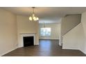 Open living room with a fireplace, new flooring, and ample space for entertaining and relaxing at 12120 Stratfield Place Cir, Pineville, NC 28134
