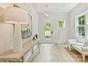 Inviting foyer boasts a light-filled space with white walls, wood floors, stylish lighting, and an exterior view at 205 Coxe Ave, Charlotte, NC 28208