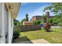 A partial view of the backyard with a detached shed and a glimpse of a brick industrial building at 209 S Ransom St, Gastonia, NC 28052