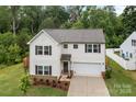 Well-maintained two-story home with landscaping, two-car garage, and manicured lawn at 2535 Andes Dr, Statesville, NC 28625