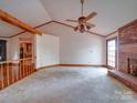 Large living room featuring a brick fireplace, and doorway entrance to kitchen at 2721 Tara Dr, Monroe, NC 28112