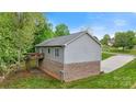 Back exterior of home showcasing a wooden deck and brick foundation at 2835 24Th Street Ne Dr, Hickory, NC 28601
