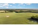 Expansive aerial view of the property showcasing rolling fields and green landscape, perfect for outdoor activities at 328 Earl Griffin Rd, Monroe, NC 28112