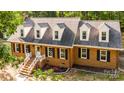 Aerial view showcasing the home's exterior with white trim, dormer windows, and a landscaped yard at 328 Earl Griffin Rd, Monroe, NC 28112