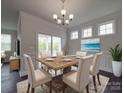 Elegant dining room featuring a chandelier, dining table set for six, and natural light at 4027 Gozzi Dr, Iron Station, NC 28080