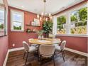 Bright dining room features a modern chandelier, table, and natural light at 411 Old Town Village Rd, Waxhaw, NC 28173