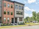 Modern townhome exterior showcasing a blend of brick and siding with black trim at 411 Old Town Village Rd, Waxhaw, NC 28173