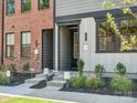 Charming townhome entrance with well-maintained landscaping and inviting curb appeal at 411 Old Town Village Rd, Waxhaw, NC 28173