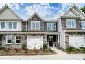 Charming townhome with a stone and siding exterior, front-entry garage, and well-maintained landscaping at 4248 Black Ct # 232, Harrisburg, NC 28075