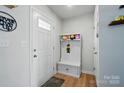 Bright entryway featuring a hall tree with bench seating, coat hooks, and storage at 4439 Wild Ridge Dr, Charlotte, NC 28215