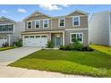 Charming two-story home with a well-kept lawn, two car garage, and bright green front door at 4439 Wild Ridge Dr, Charlotte, NC 28215