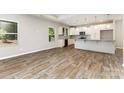Open concept kitchen featuring an island, wood floors, and stainless appliances at 5053 Arbordale Way, Mount Holly, NC 28120