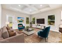 Bright living room featuring hardwood floors, coffered ceiling, and large windows at 5053 Arbordale Way, Mount Holly, NC 28120