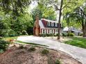 Charming two-story home with a chimney and well-manicured landscaping at 6007 Patrick Pl, Charlotte, NC 28210