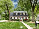 Charming two-story home with mature trees and a manicured lawn at 6007 Patrick Pl, Charlotte, NC 28210