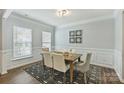 Formal dining room with modern light fixture, neutral walls, and elegant decor at 7209 Brookline Pl, Huntersville, NC 28078