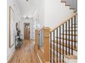 Light-filled foyer with hardwood floors, stairs with black iron railings, and a modern console table at 816 Tennyson Dr, Charlotte, NC 28208