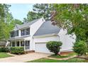 Lovely two-story home with a white exterior, gray roof, attached garage, and manicured landscaping at 9101 Strattonville Ct, Huntersville, NC 28078