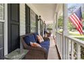 Inviting covered front porch with cozy seating, perfect for relaxing and enjoying the outdoors at 9101 Strattonville Ct, Huntersville, NC 28078