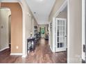 Inviting entry hall with dark wood floors and arched doorways leading to living spaces at 10508 Madison Park Dr, Charlotte, NC 28269