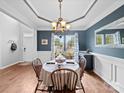 Elegant dining room with wainscoting, chandelier, and a round table perfect for Gathering meals at 1151 Gower St, Fort Mill, SC 29708