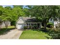 Landscaped front yard featuring a well-maintained lawn and a charming single-story home at 16117 Wrights Ferry Rd, Charlotte, NC 28278