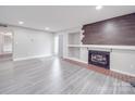 Open living room showcasing wood accent wall fireplace and modern grey flooring at 1847 J Julian Ln # A, Charlotte, NC 28208