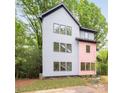 Contemporary home showcasing a modern design with clean lines, large windows, and natural landscaping at 1847 Vinton St, Charlotte, NC 28216