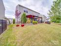 Spacious backyard featuring a patio with a cozy seating area, perfect for outdoor entertaining at 2037 Christopher Wood Ct, Indian Land, SC 29707