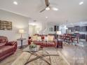 Spacious open-concept living room featuring hardwood floors, ceiling fan, and seamlessly connected kitchen at 2037 Christopher Wood Ct, Indian Land, SC 29707