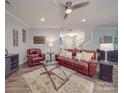 Bright living room featuring hardwood floors, ceiling fan, and comfortable leather furniture at 2037 Christopher Wood Ct, Indian Land, SC 29707