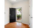 Bright entryway with hardwood floors, black front door with house number, and view of the exterior at 2137 Midnight Blue Ln, Fort Mill, SC 29708