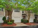 Charming townhome featuring a stone facade, lush landscaping, and a convenient one-car garage at 2137 Midnight Blue Ln, Fort Mill, SC 29708