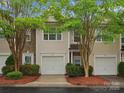 Inviting townhome exterior with attached garage, decorative stone accents, and mature trees at 2137 Midnight Blue Ln, Fort Mill, SC 29708