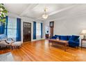 Inviting living room with hardwood floors, front door access, and blue curtains at 218 5Th Se St, Hickory, NC 28602