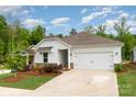 Charming single-story home featuring a two-car garage, a well-kept lawn, and fresh landscaping at 2202 Cherrybark Ct, Denver, NC 28037